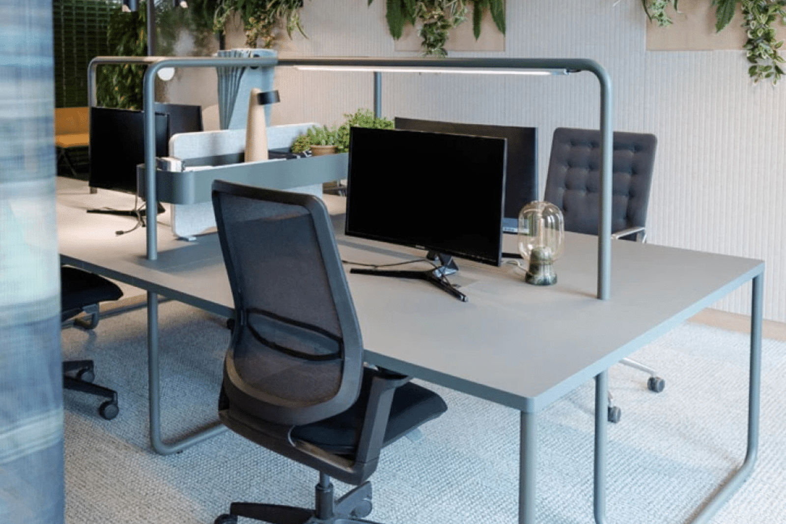 Ergonomische bureaustoel en werkplek met groene planten in een modern kantoor